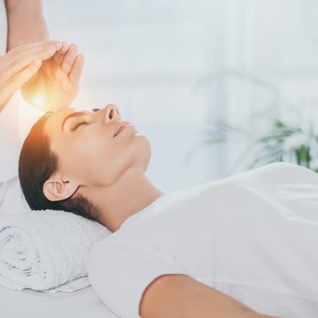 Tu Salud Consciente. Cropped shot of young woman receiving reiki therapy above head